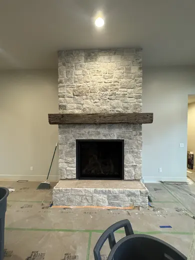 Wood mantel installation followed by the stone fireplace surround, view 3.