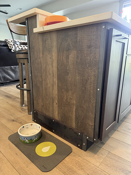 Wood island cladding with metal corner trim and visible fasteners, view 3.