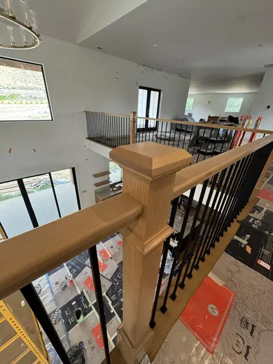 Wood treads, substantial newel posts, black balusters and warm step lighting, view 5.