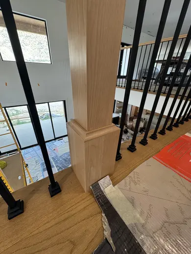 Wood treads, substantial newel posts, black balusters and warm step lighting, view 6.