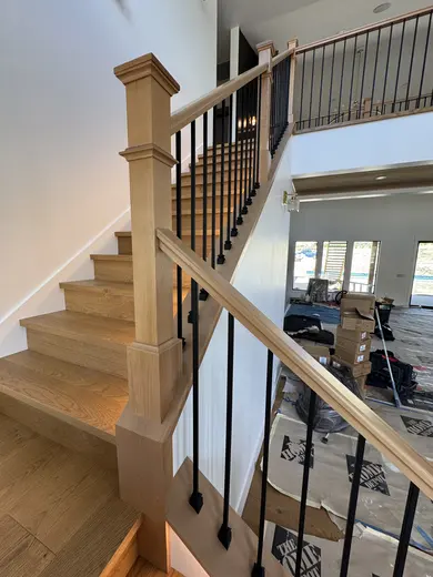 Wood treads, substantial newel posts, black balusters and warm step lighting, view 10.