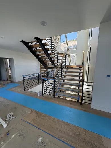 Intersecting wood slats beside the staircase, with wider installation views, view 7.