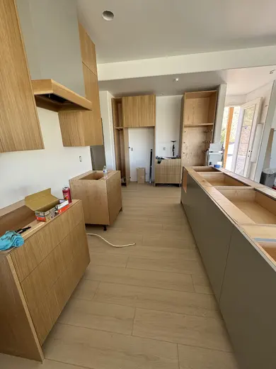 Slab wood cabinets, a gray island and a recessed wood-trimmed niche, view 5.