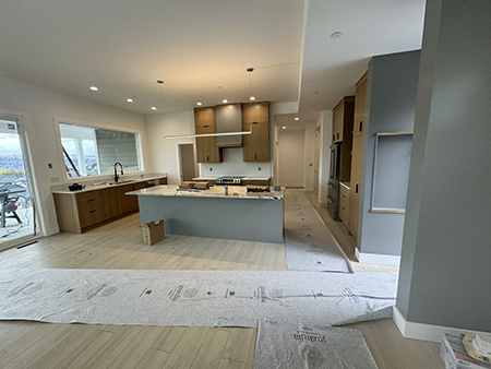 Slab wood cabinets, a gray island and a recessed wood-trimmed niche, view 11.