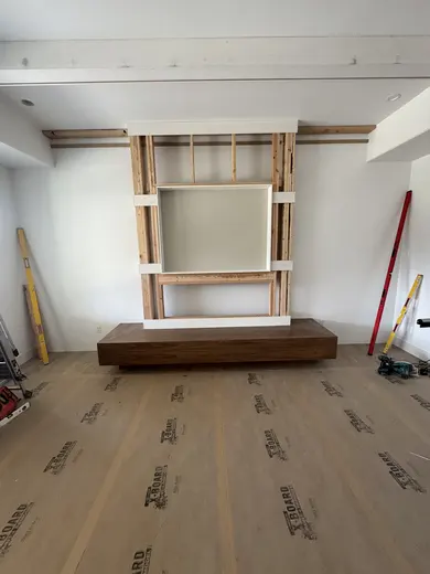 A framed media niche and lower opening progressing to panel cladding, view 1.