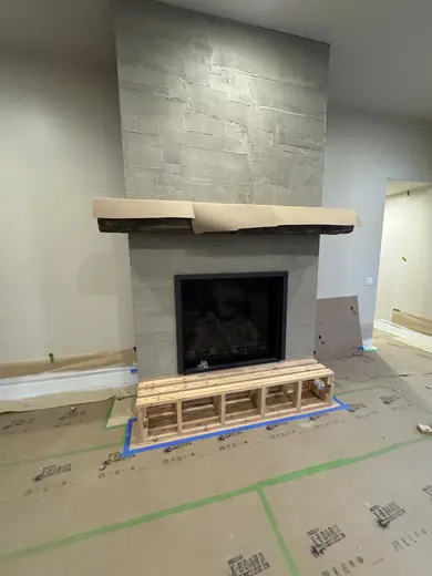Wood mantel installation followed by the stone fireplace surround, view 2.