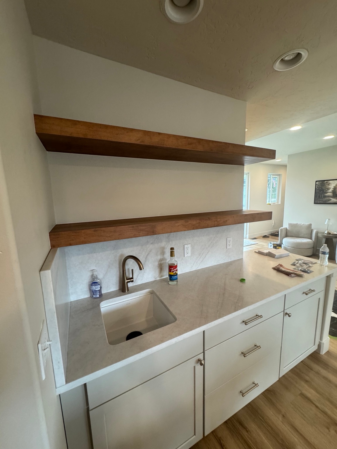 Floating shelves over a wet-bar counter