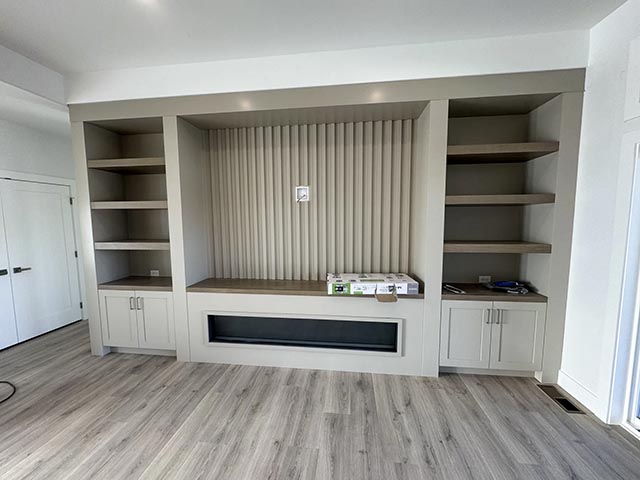 Allison Pl fireplace with fluted panel, shelving and built-in cabinets
